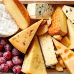 various types of cheese in wooden box on white wooden table, top view; Shutterstock ID 534607291; use: web; Client: tasteofhome.com
